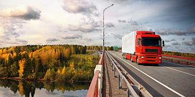 Red truck crossing a bridge
