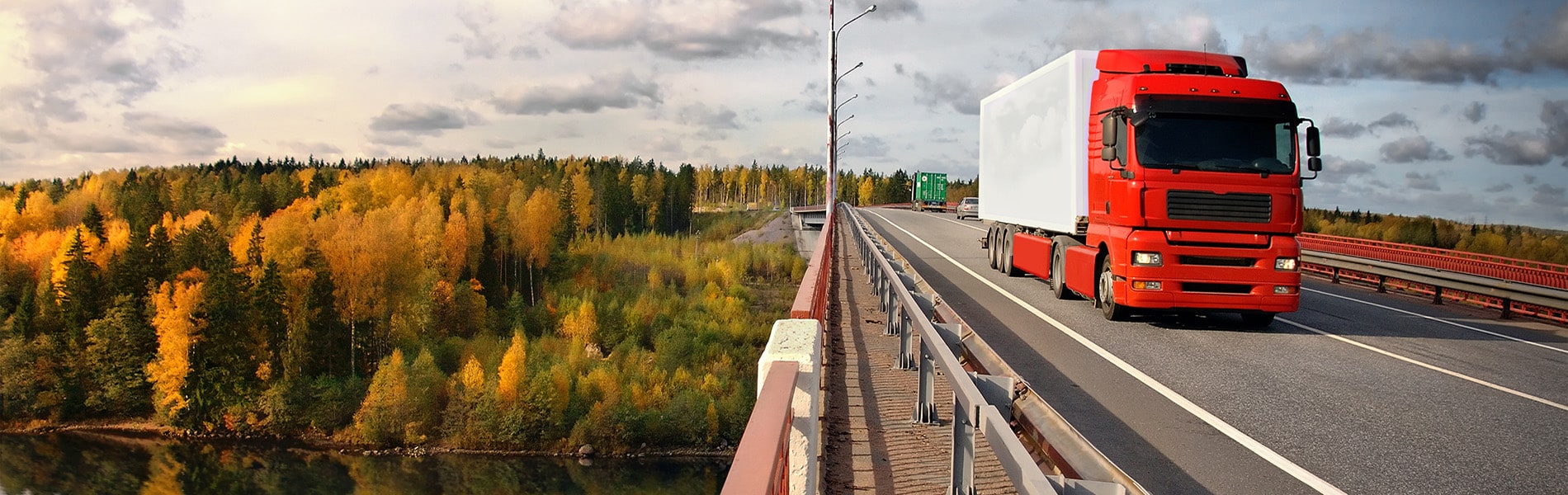 Red truck crossing a bridge