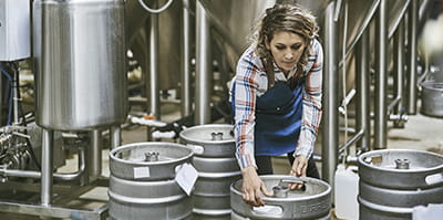 woman moving a beer keg