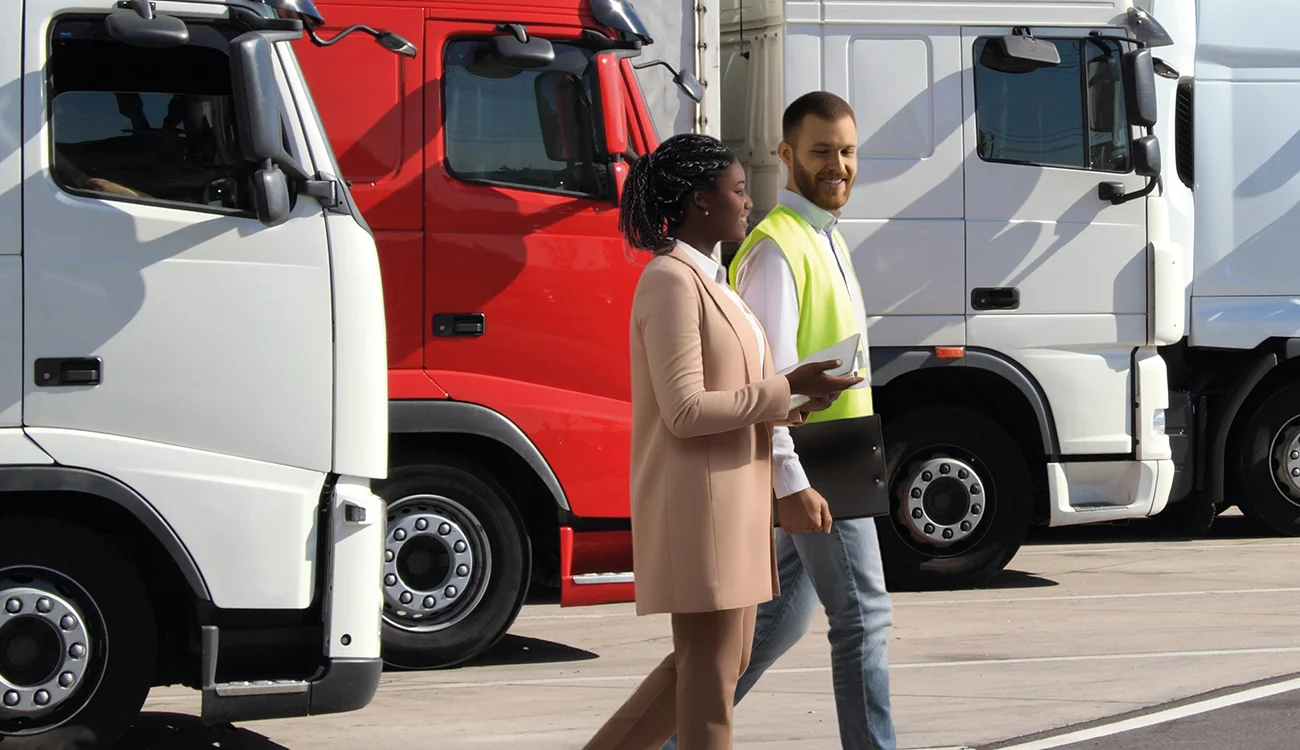 People walking past trucks