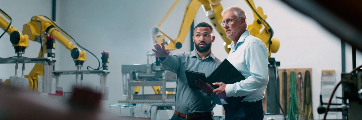 Two men discussing in a manufacturing room